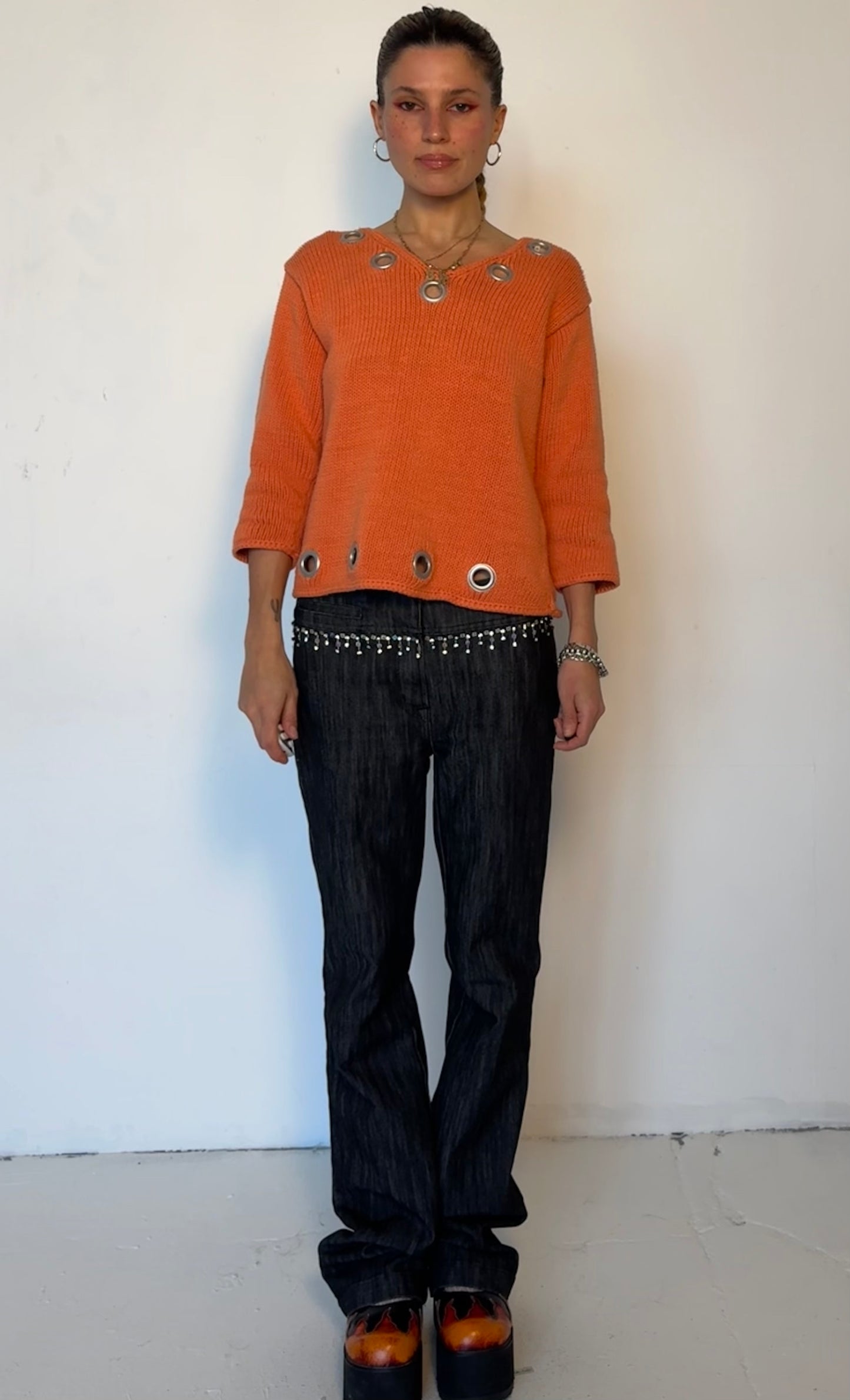 Orange grommet sweater